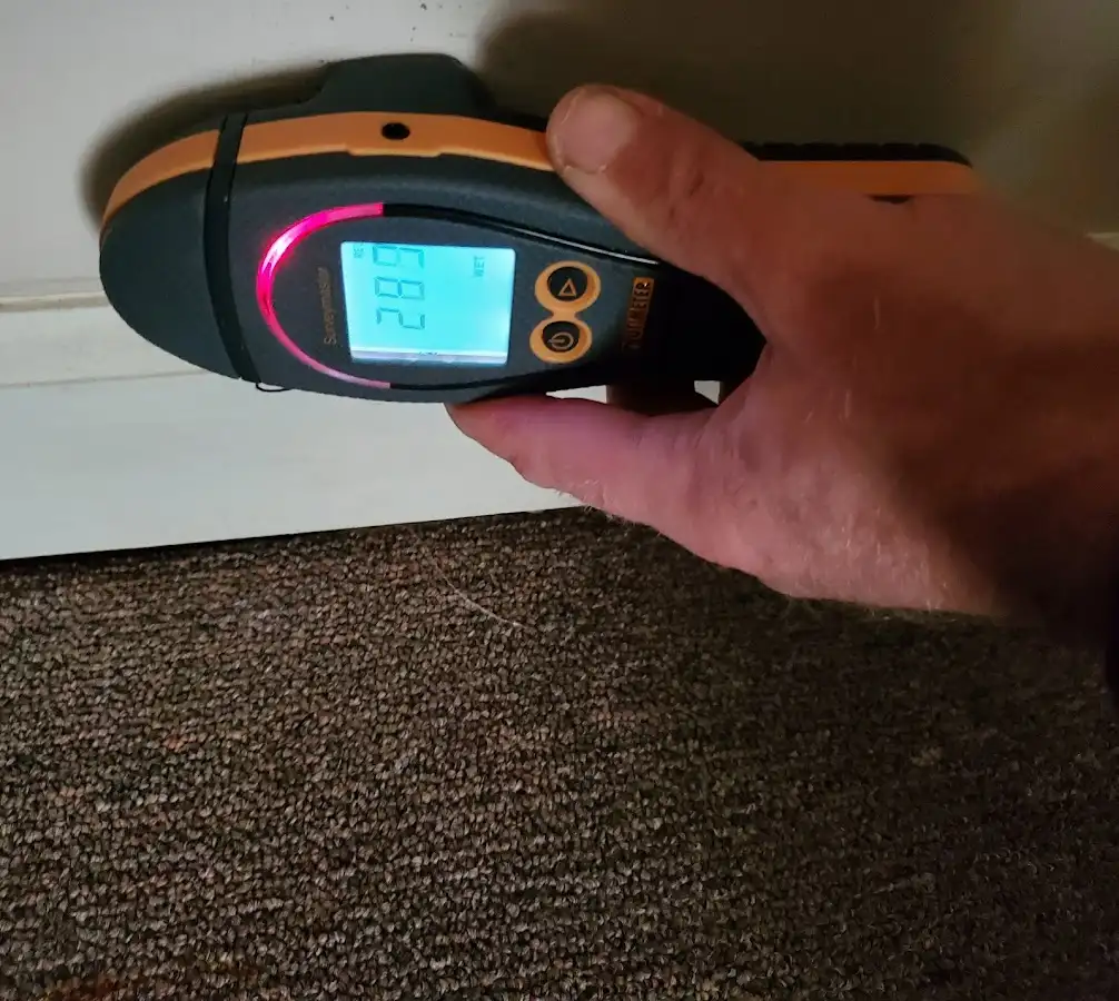 Moisture detection at baseboard during Storm Damage Restoration in Ellsworth